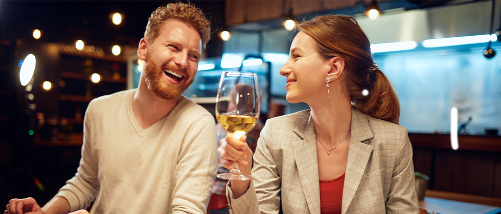 A couple dining and smiling at each other