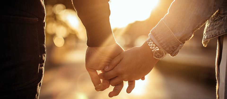 Man and woman holding hands