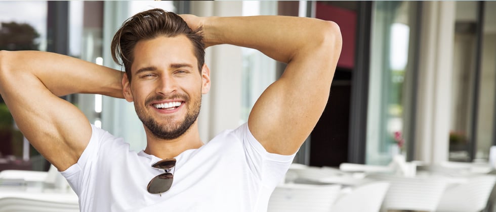 Short guy smiles at the camera