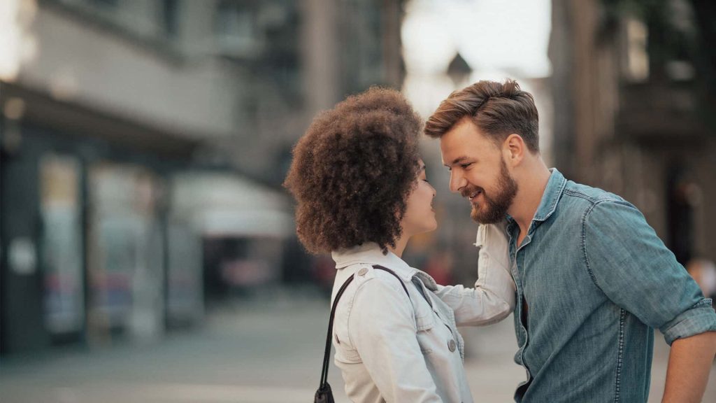 Interracial dating symbolized by a man and woman who are faced with each other and fall in love