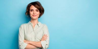 A woman with her arms crossed looking confidently into the camera