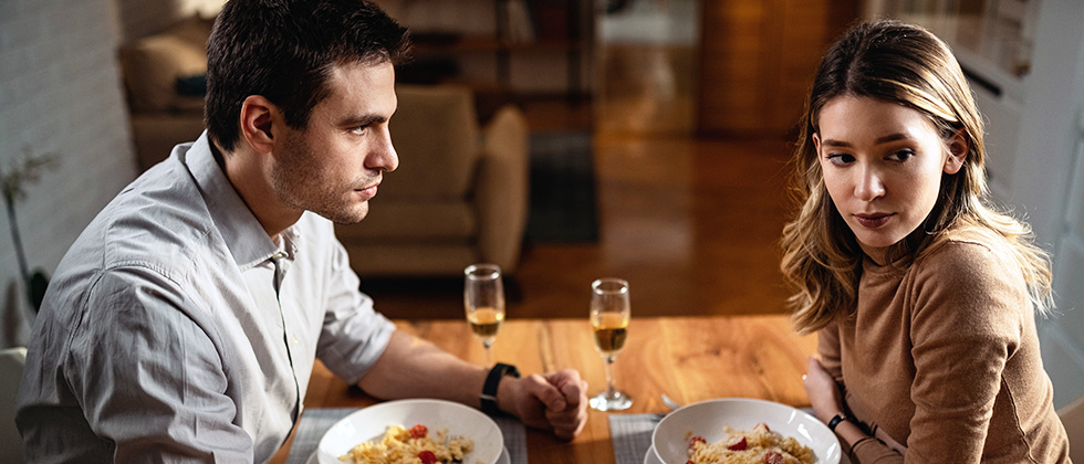 A couple share an uncomfortable dinner