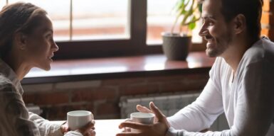 Couple on a first date having a conversation over coffee