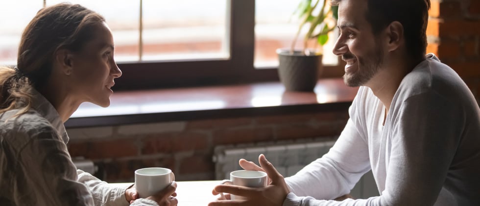 Couple on a first date having a conversation over coffee