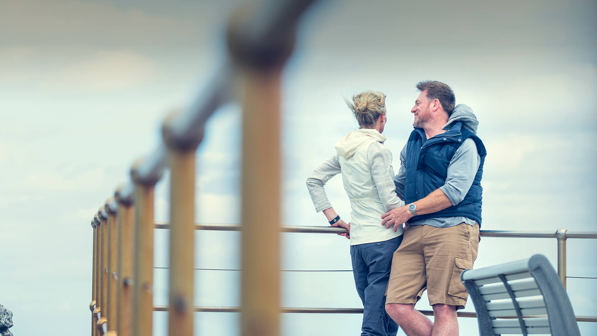 Man and woman found each other dating in their 40s and stand happy at the bridge in UK