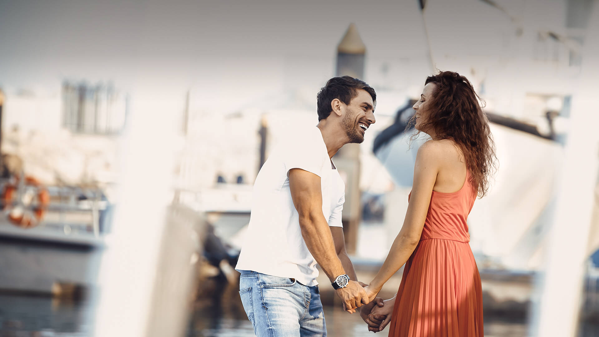 Arab dating symbolized by a man and woman holding hands and standing happily at the port in UK