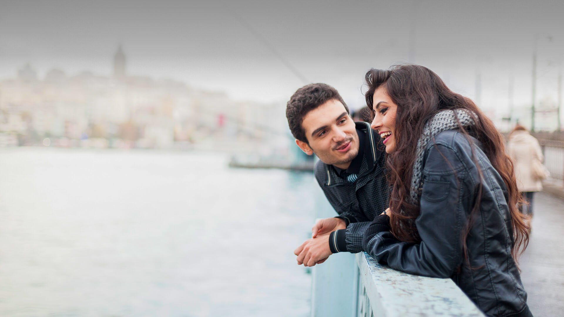 Pakistani dating symbolized by a man and woman who enjoy their first date in a bridge in UK