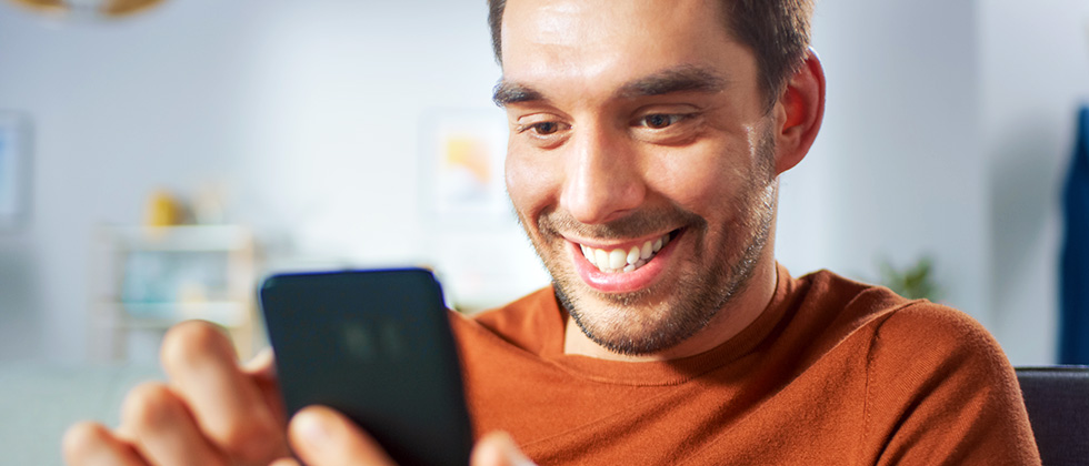 A man checks out dating profiles on his phone
