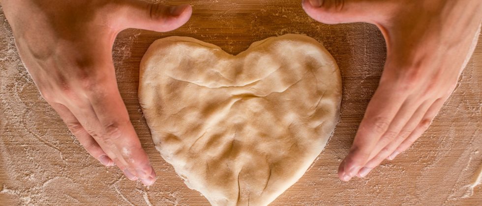 Baker shaping heart shaped dough