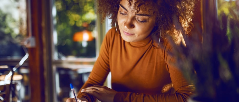 Woman sitting at a café thinking about 'Am I ready for a relationship?'