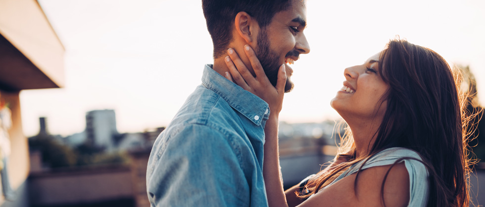 Older couple lie in each other arms and laugh as symbol what is love