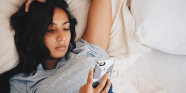how to get over a breakup symbolized by a woman lying thoughtful in her bed