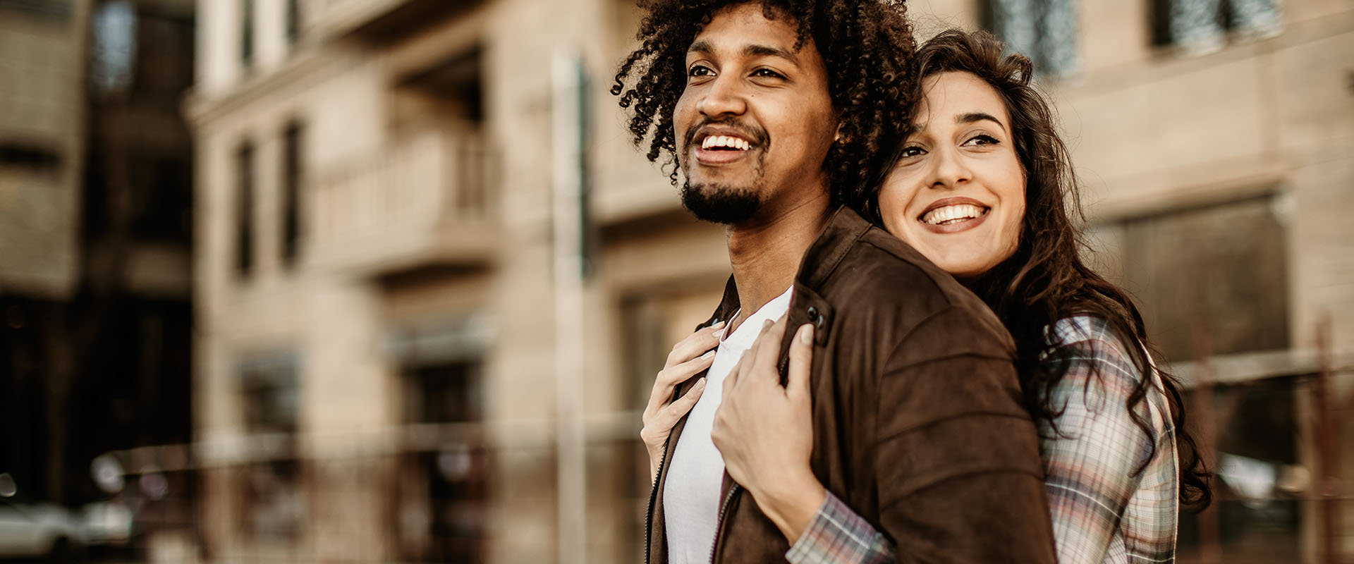 Woman hugging man from behind as a symbol of how to find the right person