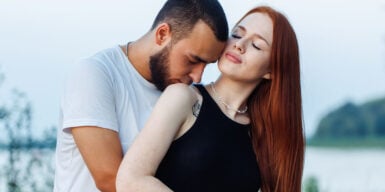 Man kisses woman on shoulder as symbol of being vulnerable