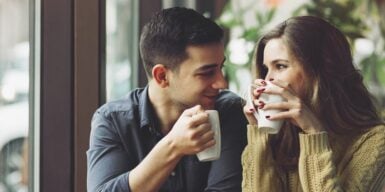 Cute couple having a coffee date gazing into each other's eyes