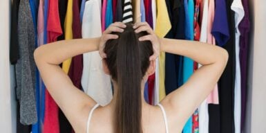 Woman standing in front of her closet not knowing what to wear