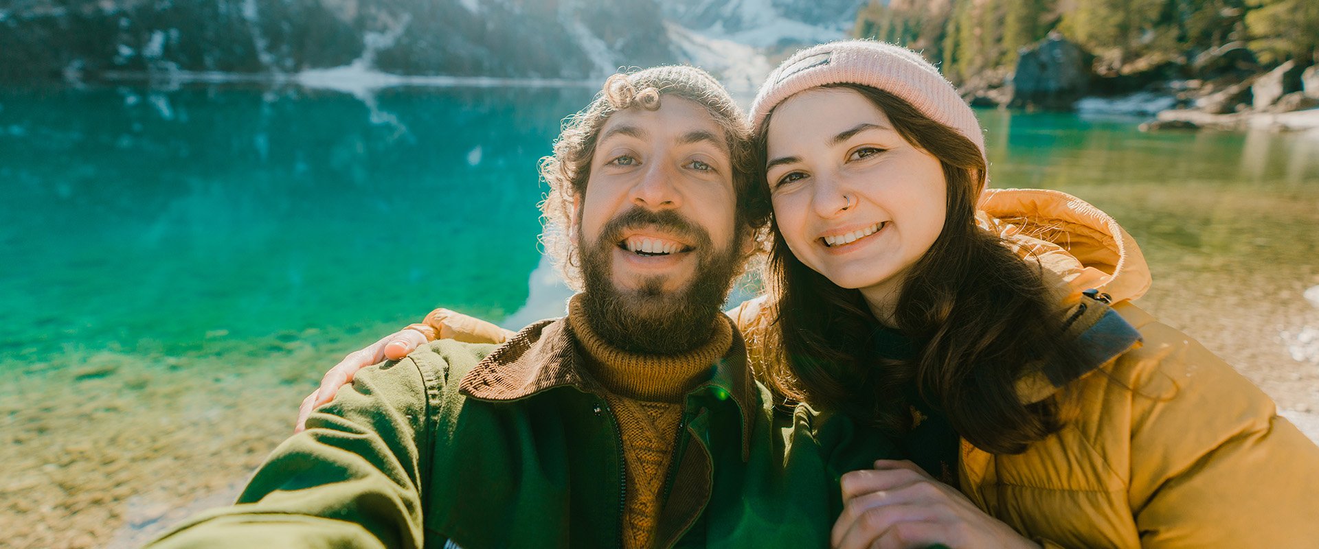 Man and woman smile in camera as an example of compatibility in a relationship