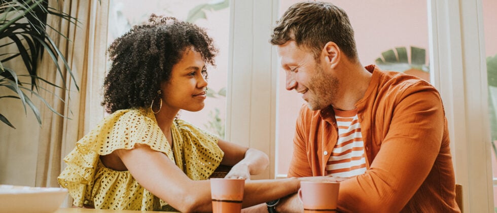 Man and woman drinking tea together and talking as a symbol of core values in a relationship