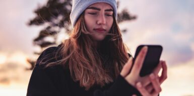 Woman looks hurt at her cell phone as symbol for dating multiple people