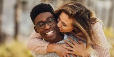 Woman kissing on the cheek as an example of dating outside your race