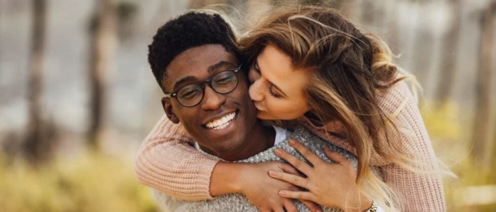 Woman kissing on the cheek as an example of dating outside your race