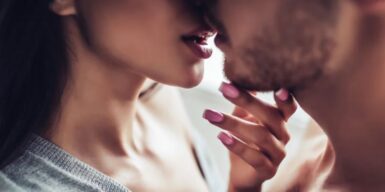 Woman holding man's chin and they are about to kiss as symbol for is it just sex