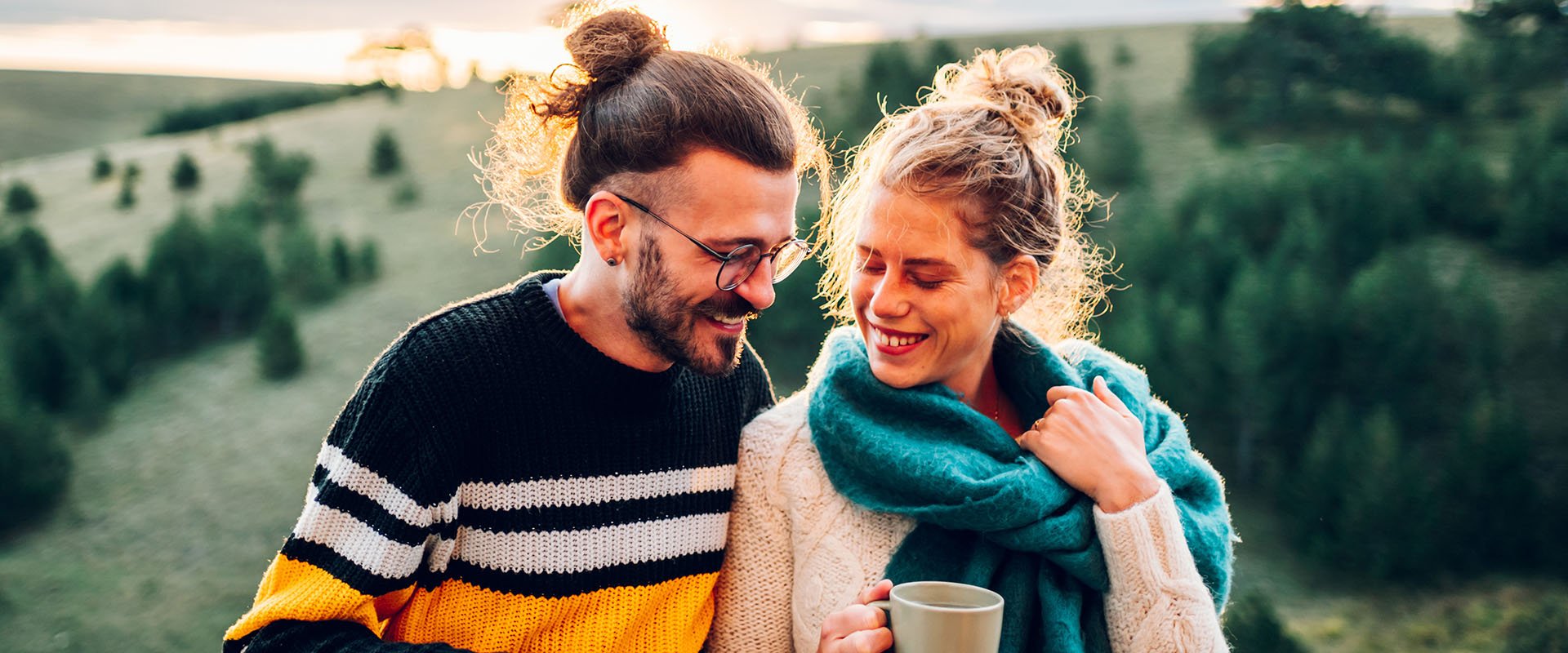 Man and woman laughing together outside in nature symbolizing different types of relationship