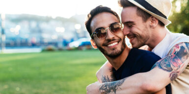 Two men lying in each other's arms as an example of a gay relationship