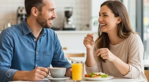 A couple sitting at a table enjoying brunch with orange juice and coffee.