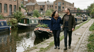 A couple walking along the leeds, liverpool canal pathway.