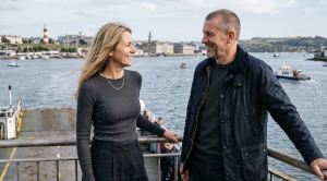 A couple standing on a ferry in plymouth. (Generated with AI)
