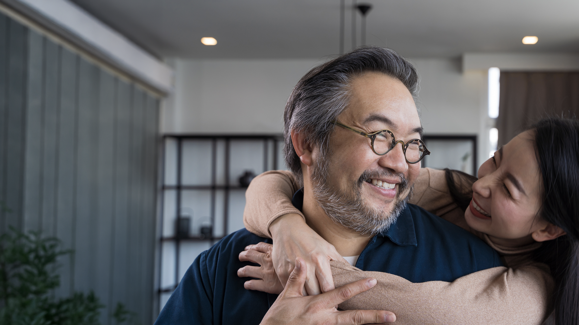A woman and a man embrace and smile at each other as a symbol of Korean dating