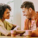 Man and woman look at each other and talk as a symbol for questions to ask