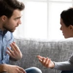 A couple having a heated argument on their couch