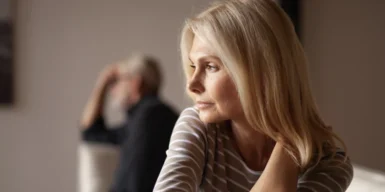 A couple who just broke up. She's slowing turning around to her ex partner in the background.