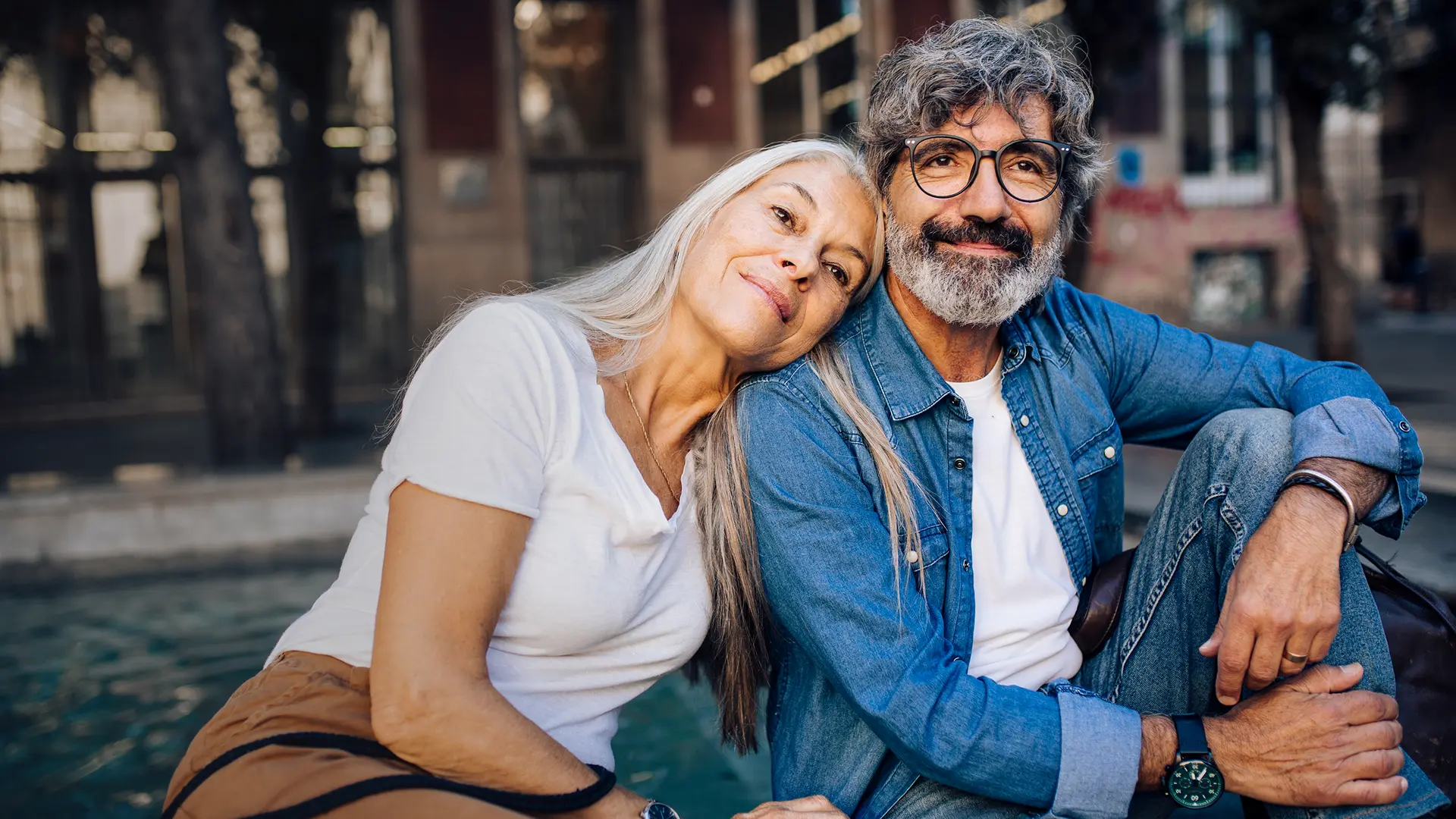 A woman and a man over 50 sitting next to each other.